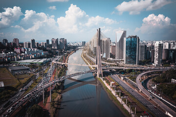 Aerial View Of Pinheiros River, Cable Stay Bridge And City Skyline During Peak Hour In Central Business District Of Sao Paulo, Brazil