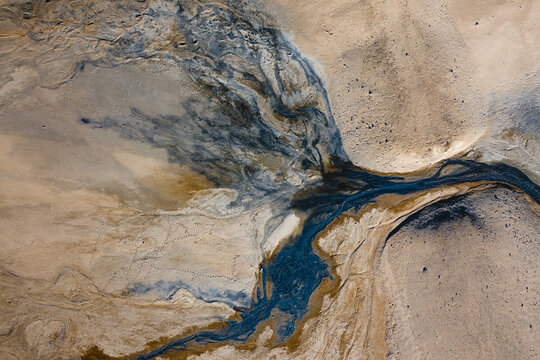 Aerial view of abstract patterns created by hotsprings and mudpots, in Hverir geothermal area in North Iceland. - Powered by Adobe
