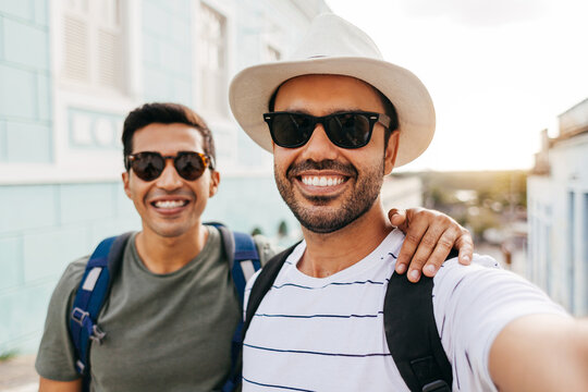 Two happy male tourists taking self portrait. Travel and love concept in Latin America