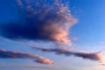 Fototapeta na wymiar Evening sunset landscape orange clouds and a trace of the plane