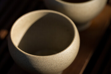 Ceramic bowls made of clay on a wooden background.