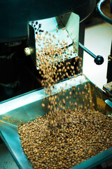 Close up photo of coffee roasting machine in process.