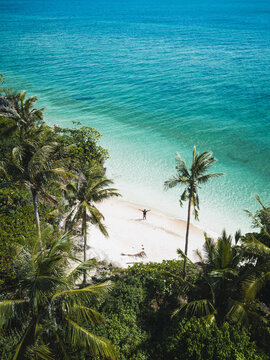 Aerial view of a man on the shore of the beach in Candabong, Anda, Bohol, Philippines