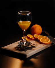 cup with orange juice on little table