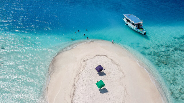 Aerial view of a sandbank, North Mal&radic;&copy; Atoll, Maldives, Indian Ocean with an anchored dhoni, boat and people swimmimg, sunbathing