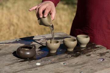 Chinese tea ceremony. Ceramic teapot made of clay and bowls on a wooden background.
