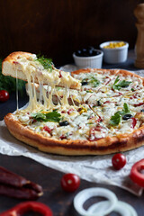 Traditional pizza pepperoni, assorted sausage, olives, arugula, corn, mozzarella