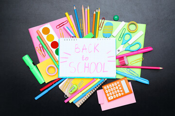 Different school supplies with text Back to School on black background