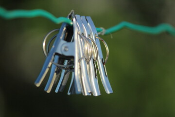 group of color and stainless steel clips hang on the rope without clothes