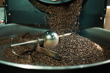 Close up photo of coffee roasting machine in process.