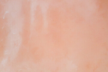 Fototapeta premium Non-uniform pale pink surface of a salty reservoir. Texture. Shooting from a drone.