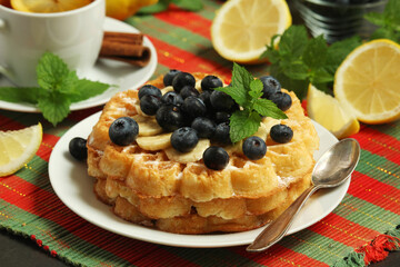 Belgian waffles with blueberry and a cup of tea with lemon