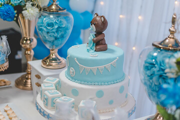 baby shower boy cake, teddy bear doll on top