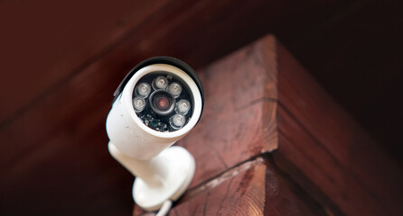 Naklejka premium Security CCTV camera in private wooden house building, protection and video recording