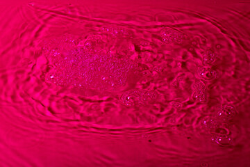 splash of water on a red background. Abstract wallpaper
