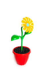 Yellow plastic flower in the red pot