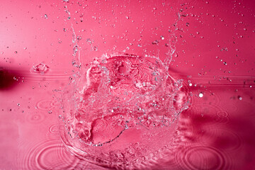 splash of water on a red background. Abstract wallpaper