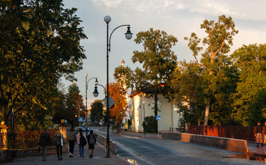 Grodno, Belarus, August 25, 2020: Street of the old city in the rays of the evening sun.