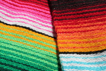 Mexican cinco de mayo poncho Mexico serape background dia de los Muertos Mexican blanket rug fiesta traditional with stripes copy space - stock photo photograph