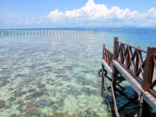 Looking out at the clear waters and a distant dock at Sipadan Island, Sabah, Borneo, Malaysia