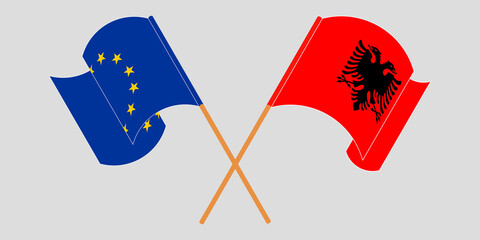 Crossed and waving flags of Albania and the EU