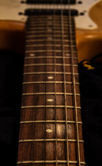 A closed photo of a guitar painted like wood
