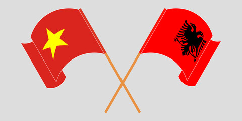 Crossed and waving flags of Albania and Vietnam