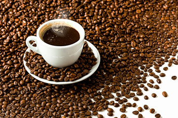 Cup with coffee on the background of coffee beans