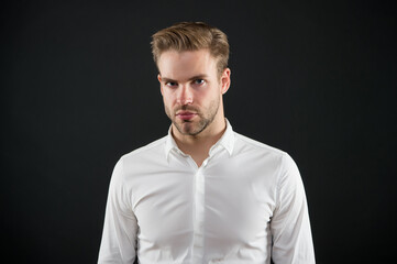 Handsome caucasian guy with unshaven face skin hair and stylish haircut grey background, salon