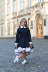 Practice makes perfect. Little kid make curtsy outdoors. Small ballerina wear uniform. Back to school fashion. Formal dress code. September 1. Back to school. Dance education. Dancing is perfection