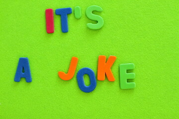 It's a joke lettering, colorful letters on green textured background, message of 1 - st of April copy space