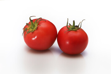 Two tomatoes isolated on white