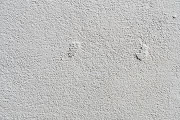 White or gray concrete wall is a decorative or textured surface. Can be used as a background or for design purposes