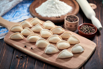 raw dumplings on the wooden board