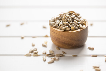 Peeled sunflower seeds in wooden bowl.