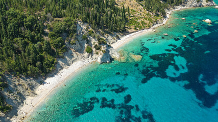 Aerial photo taken by drone of Caribbean tropical exotic steep cliff island bay with turquoise clear sea sandy beaches and rare limestone trees