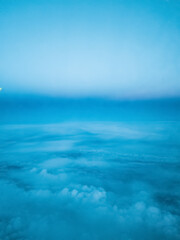 clouds. top view from the window of an airplane flying in the clouds. clear blue sky under high clouds located