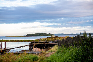 landscape of the island against the background of old wooden boats lying on the shore