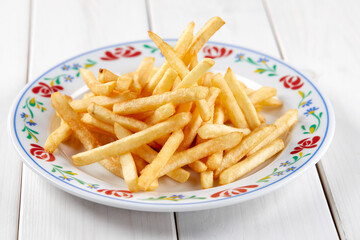 golden french fries on the wooden background