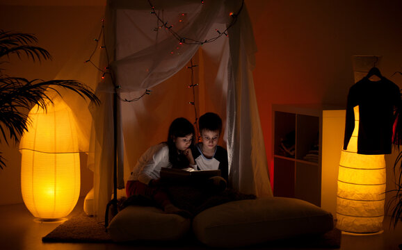 Brother and sister reading before sleep.