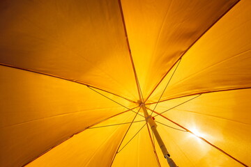 a yellow umbrella under the sun
