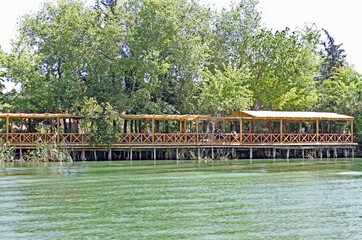 Fototapeta na wymiar A restaurant wooden terrace by a river in Dalyan, Turkey