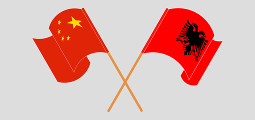 Crossed and waving flags of Albania and China