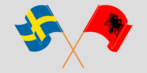 Crossed and waving flags of Albania and Sweden