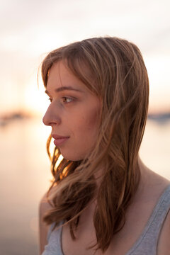 Young woman backlit by sunset