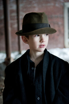 Portrait of a young boy wearing an old hat
