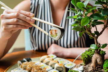 woman eating sushi in the restaurant