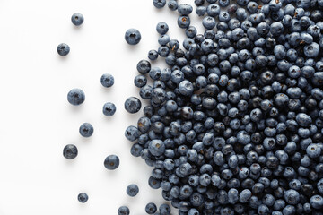 Blueberries scattered on a white background. View from above