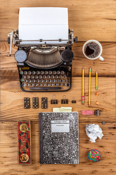 Antique Typewriter on an Author's Desk Top with Composition Book and Writing Impliments