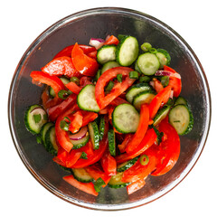 Isolate of a round dish with vitamin salad from fresh vegetables. Tomatoes, cucumbers, peppers, seasoned with oil. View from above.